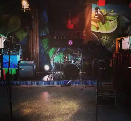 Stage setup with drum kit and colorful murals at Dandarì Disco Pub Villanova Italy — bachata, salsa venue in Villanova di Castenaso