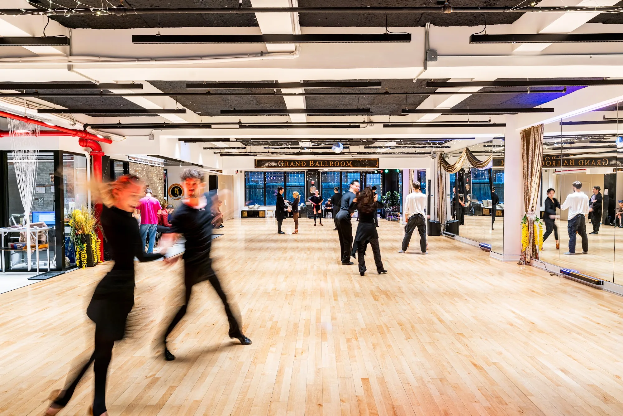 Dancers in motion on the wooden floor of EPA Dance Academy's Grand Ballroom in New York