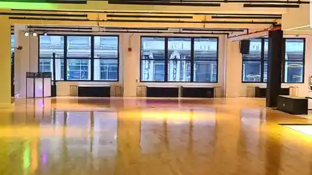 Sunlit wooden dance floor and tall windows inside EPA Dance Academy studio in New York — zouk venue in New York