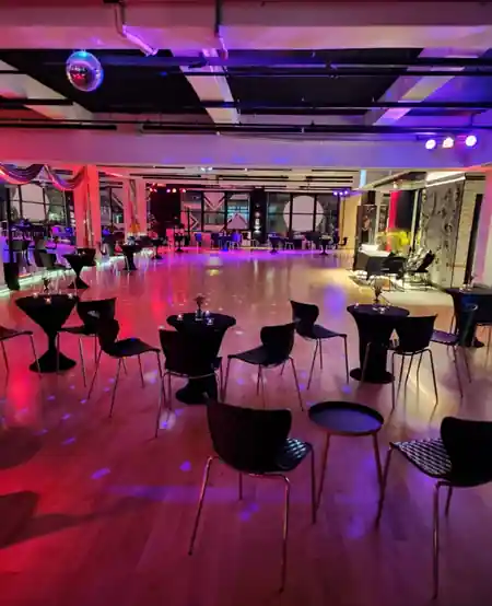 Disco ball, cocktail tables and purple lighting set up for a social night at EPA Dance Academy in New York — zouk venue in New York
