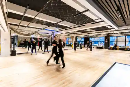 Dancers practicing on the wooden floor during a class at EPA Dance Academy in New York with fairy lights overhead — zouk venue in New York