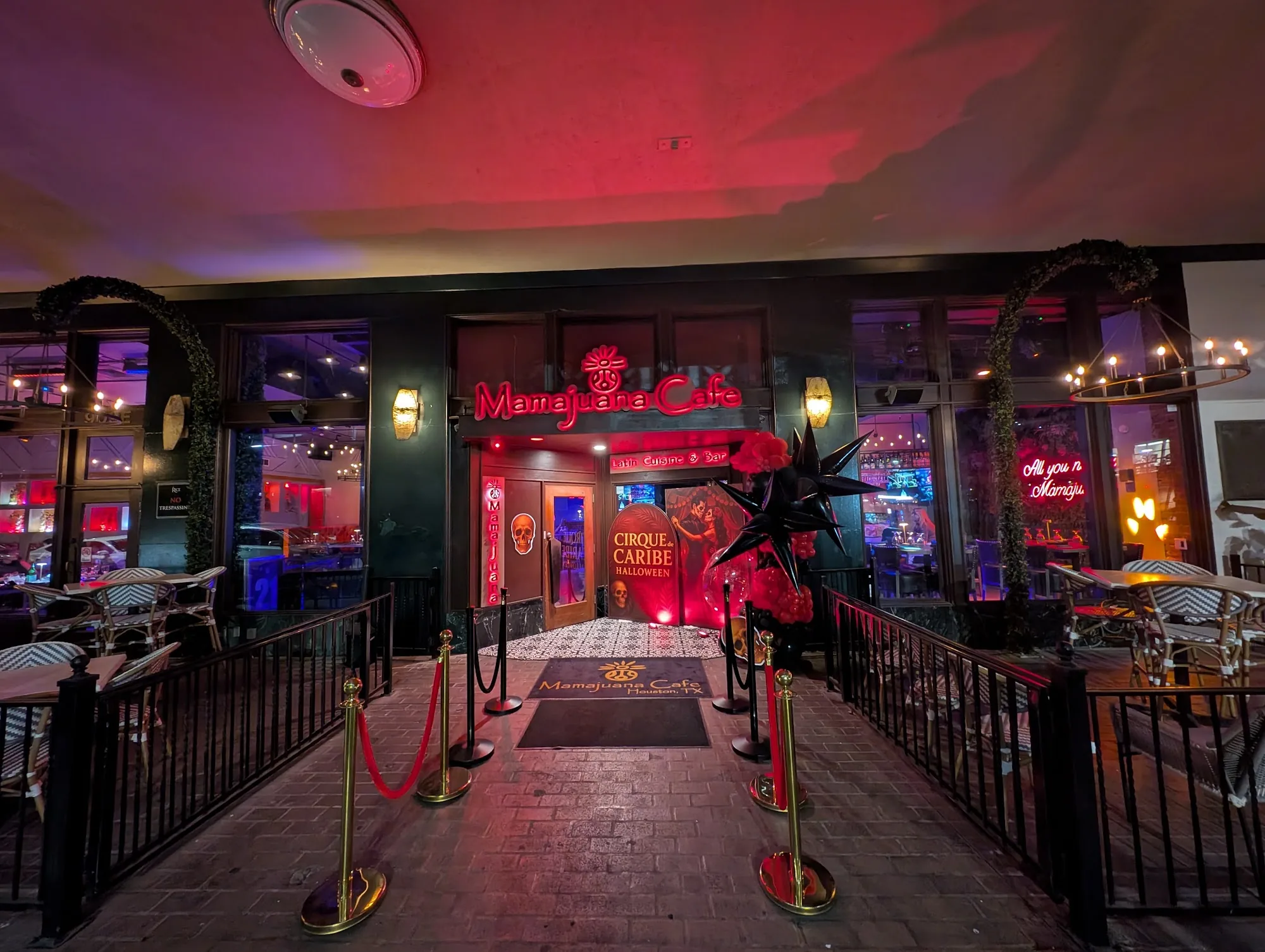 Red-lit night entrance of Mamajuana Cafe Latin Cuisine and Bar, Houston