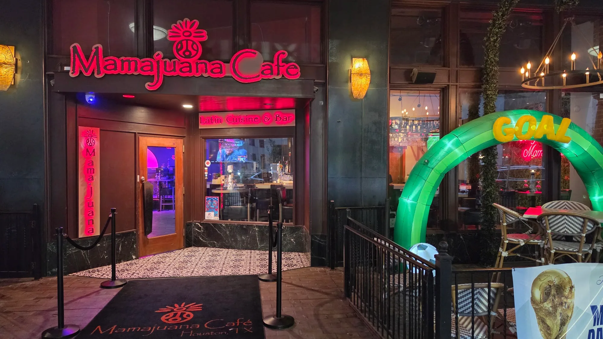 Mamajuana Cafe entrance with Latin Cuisine and Bar signage and logo mat, Houston