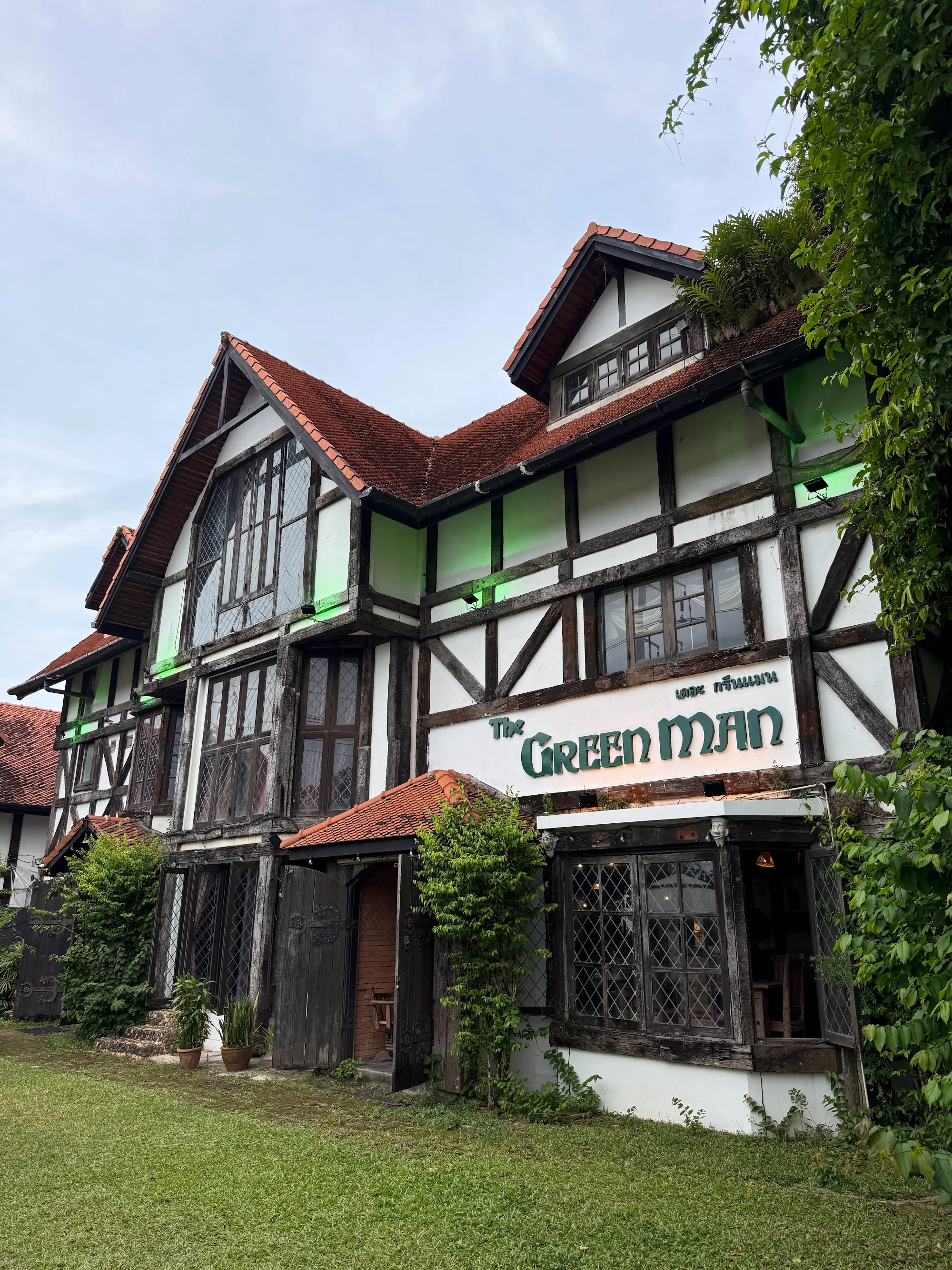 Tudor-style exterior of The Green Man pub with prominent signage in Phuket, Thailand