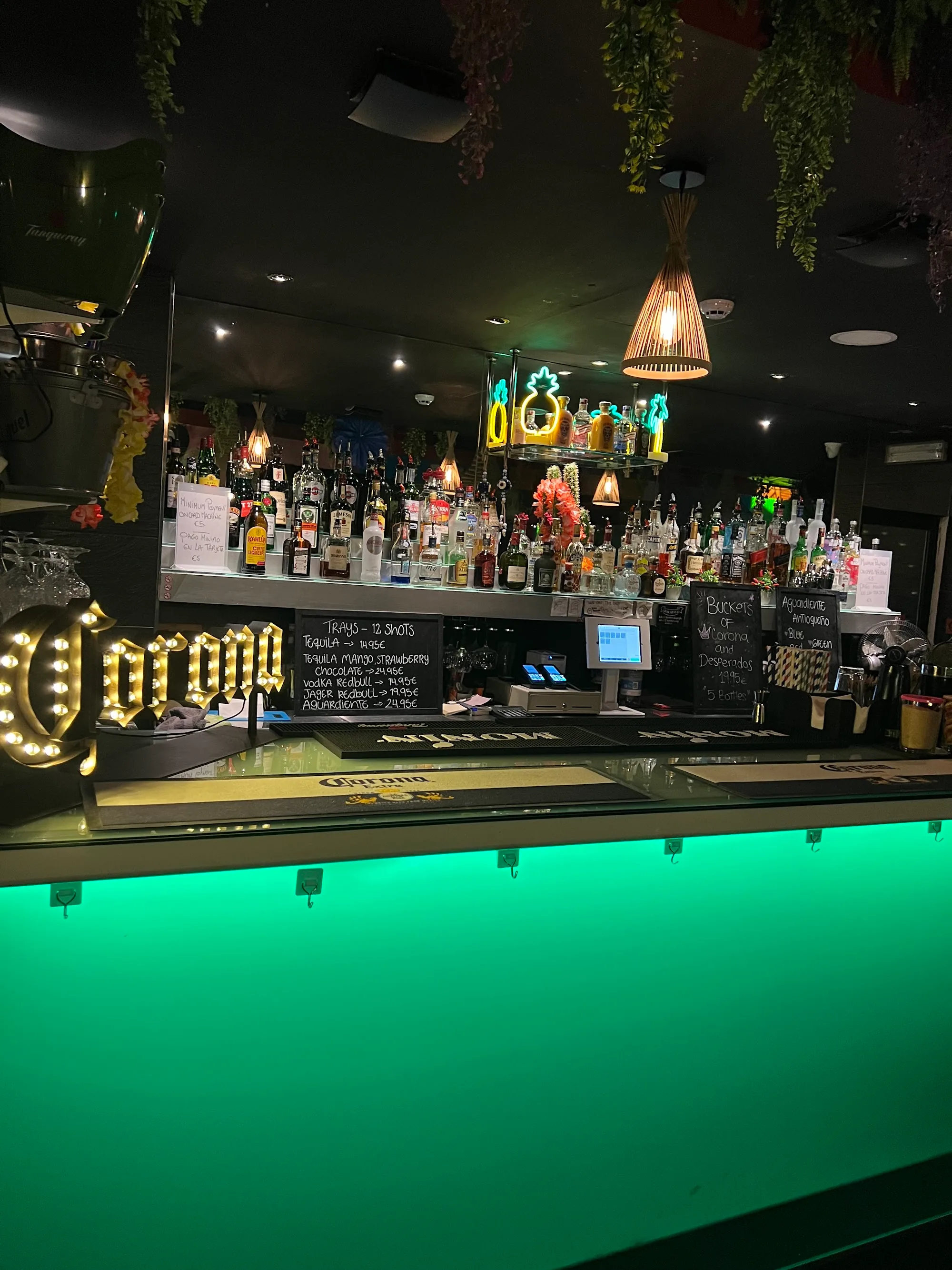 Bar with green neon lighting and Corona sign at Barrio Latino Malta, Sliema