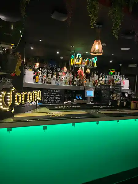 Bar with green neon lighting and Corona sign at Barrio Latino Malta, Sliema — salsa, bachata, kizomba venue in Sliema