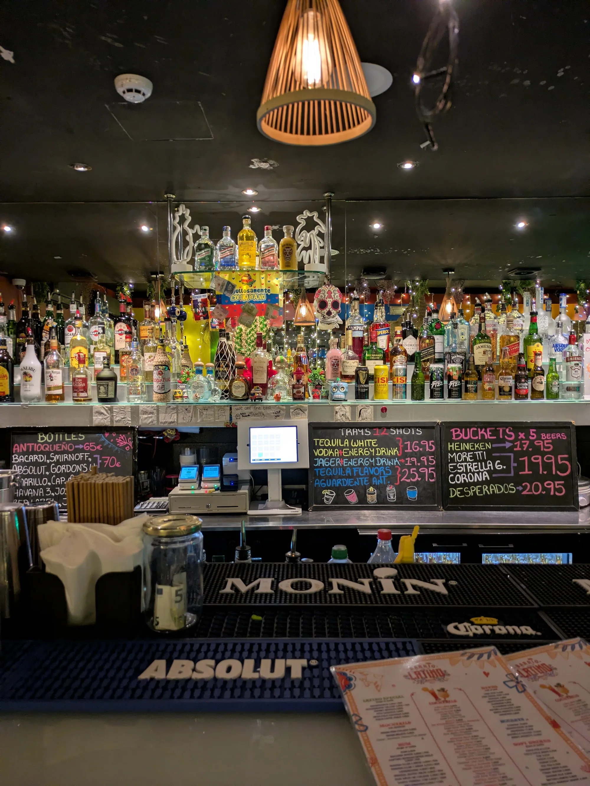 Well-stocked bar with skull decorations and cocktail menu at Barrio Latino Malta