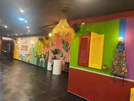 Colorful interior with Barrio Latino mural and rattan lamp at Barrio Latino Malta, Sliema — salsa, bachata, kizomba venue in Sliema