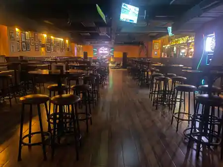 Empty interior of London Pub Kathmandu with bar stools, high tables and a dance floor space — salsa venue in Kathmandu