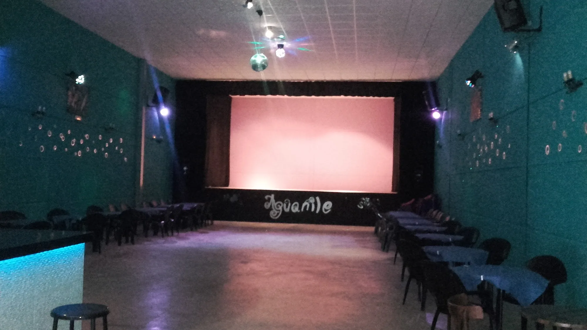 Sala Aguanile empty dance hall with stage and disco ball in Cordoba