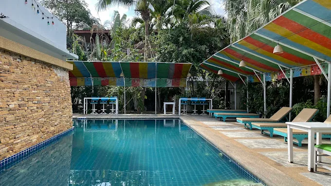 Swimming pool at Greenlight Cafe with lush tropical greenery in Koh Samui