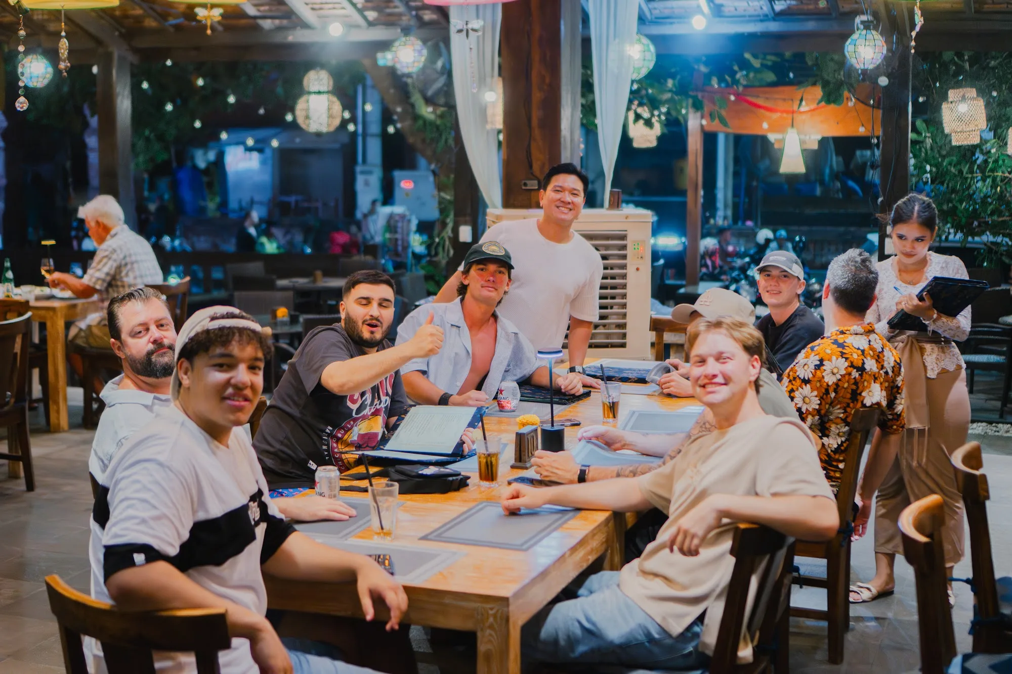 Group of friends gathered at Mezza Mediterranean Cuisine in Bali under hanging lanterns