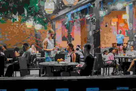 Lively crowd seated under hanging lanterns at Mezza Mediterranean Cuisine in Bali — salsa, bachata, kizomba venue in Bali