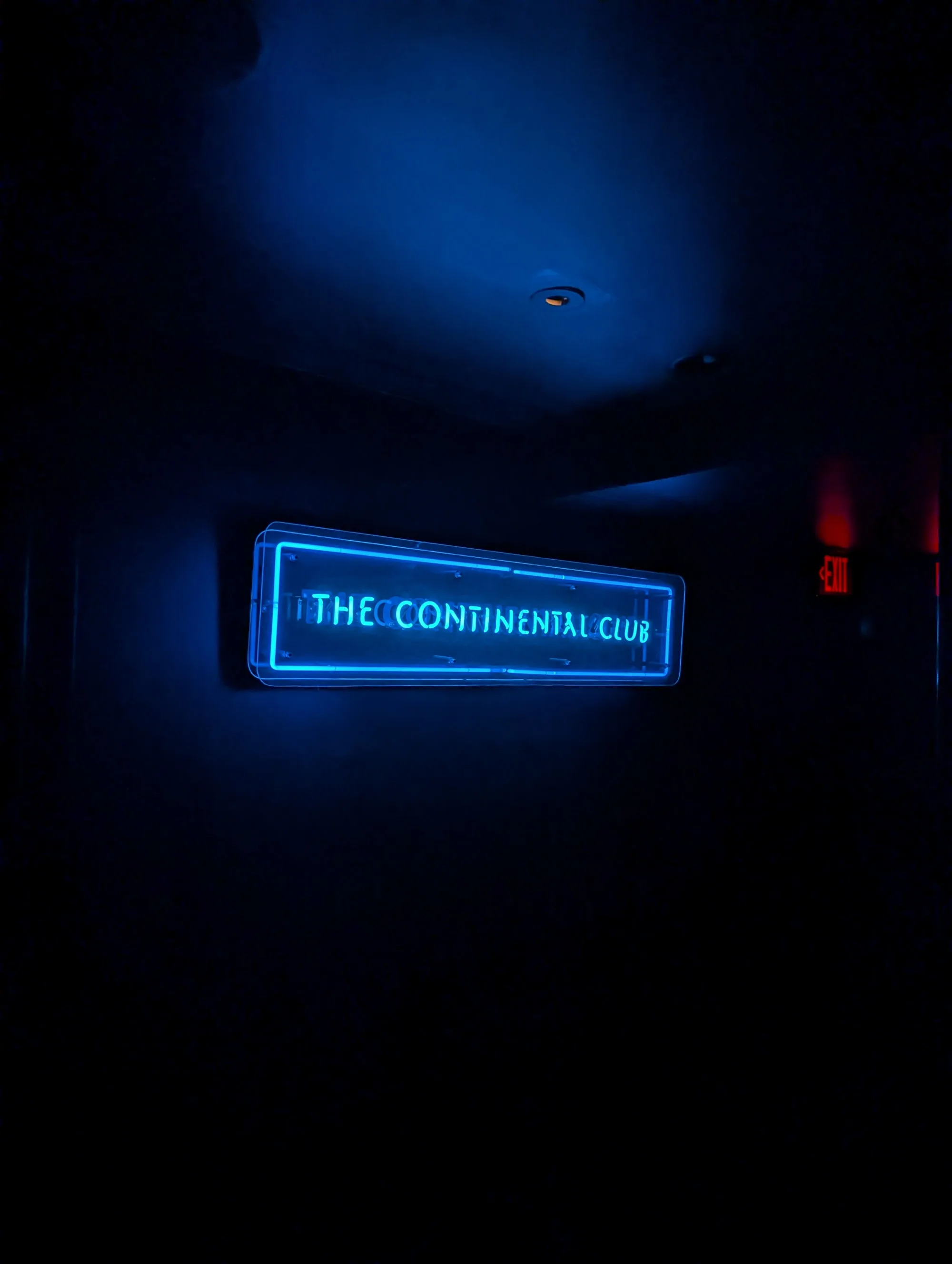 Neon sign glowing blue inside The Continental Club Los Angeles