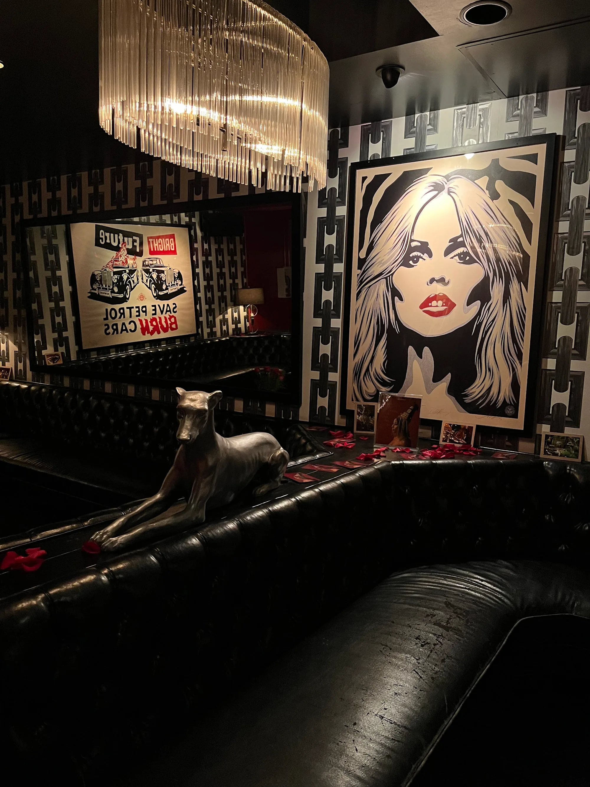 Dark lounge corner with vintage art and leather seating at The Continental Club LA