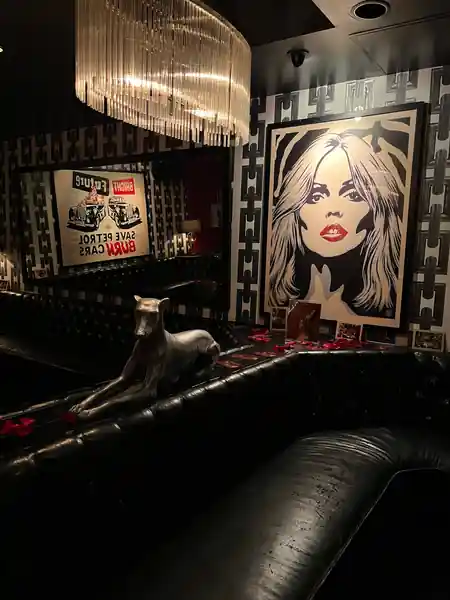 Dark lounge corner with vintage art and leather seating at The Continental Club LA — salsa, bachata venue in Los Angeles