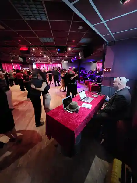 DJ booth and social dancers at a Sensation Dance School party night in Paris — bachata venue in Paris