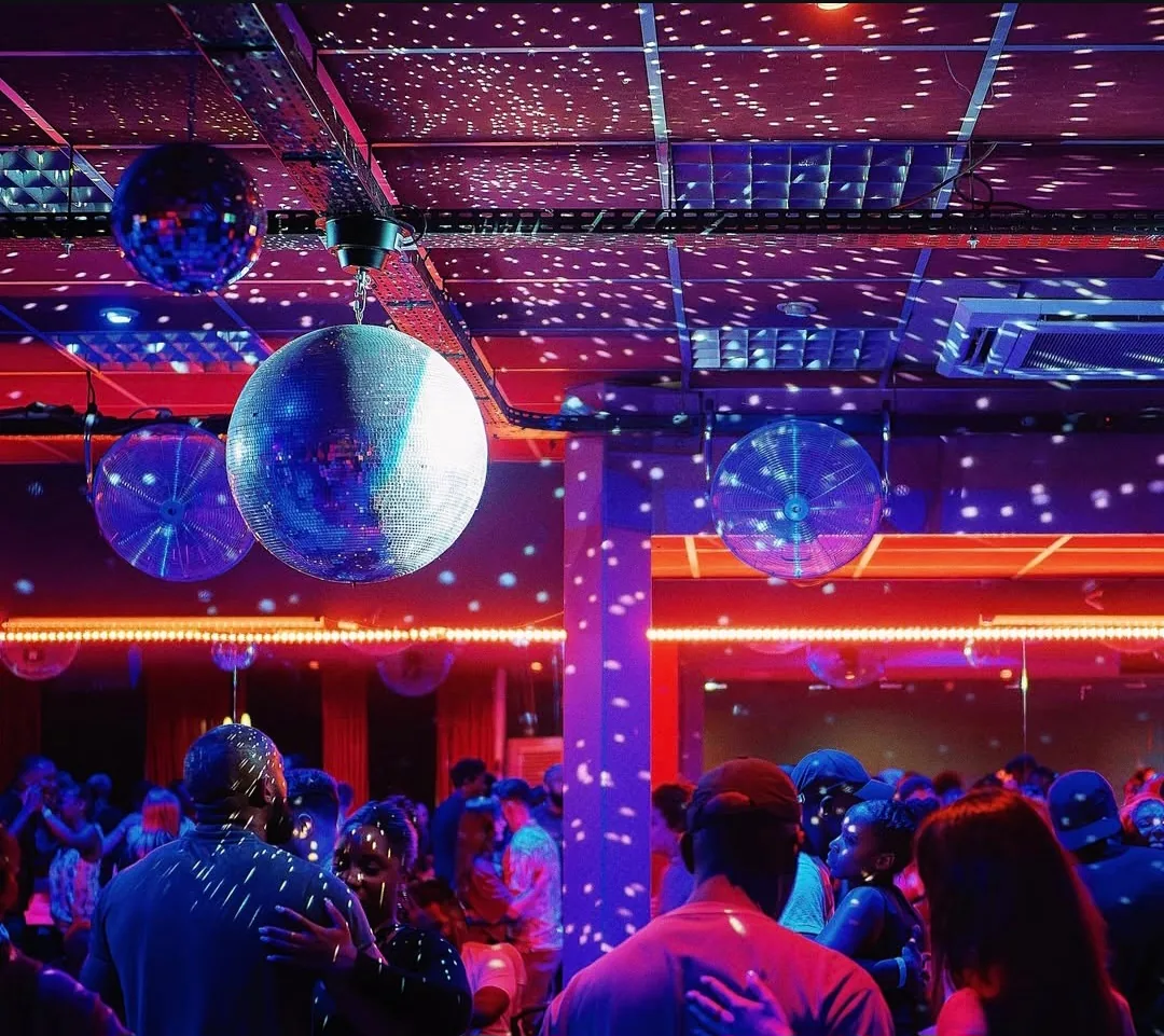 Disco balls and social dancers at a salsa bachata party night at Sensation Dance School in Paris