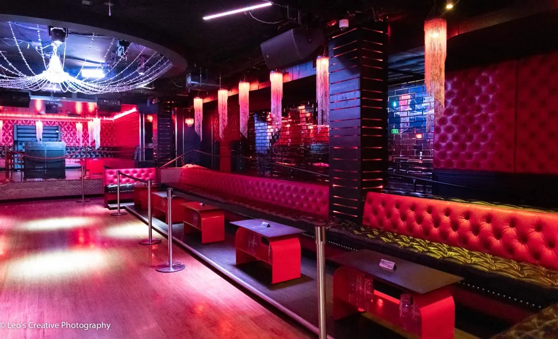Red lounge and dance floor interior with chandeliers at Sevilla Nightclub, San Diego