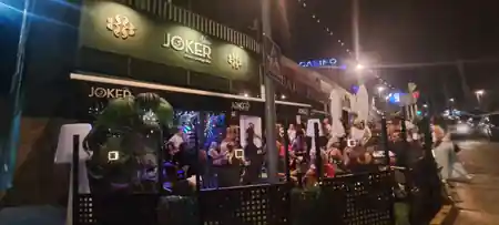 New Joker Music Lounge Bar in Tomares Spain — branded nighttime exterior with crowd inside and Joker sign — salsa, bachata, kizomba venue in Tomares