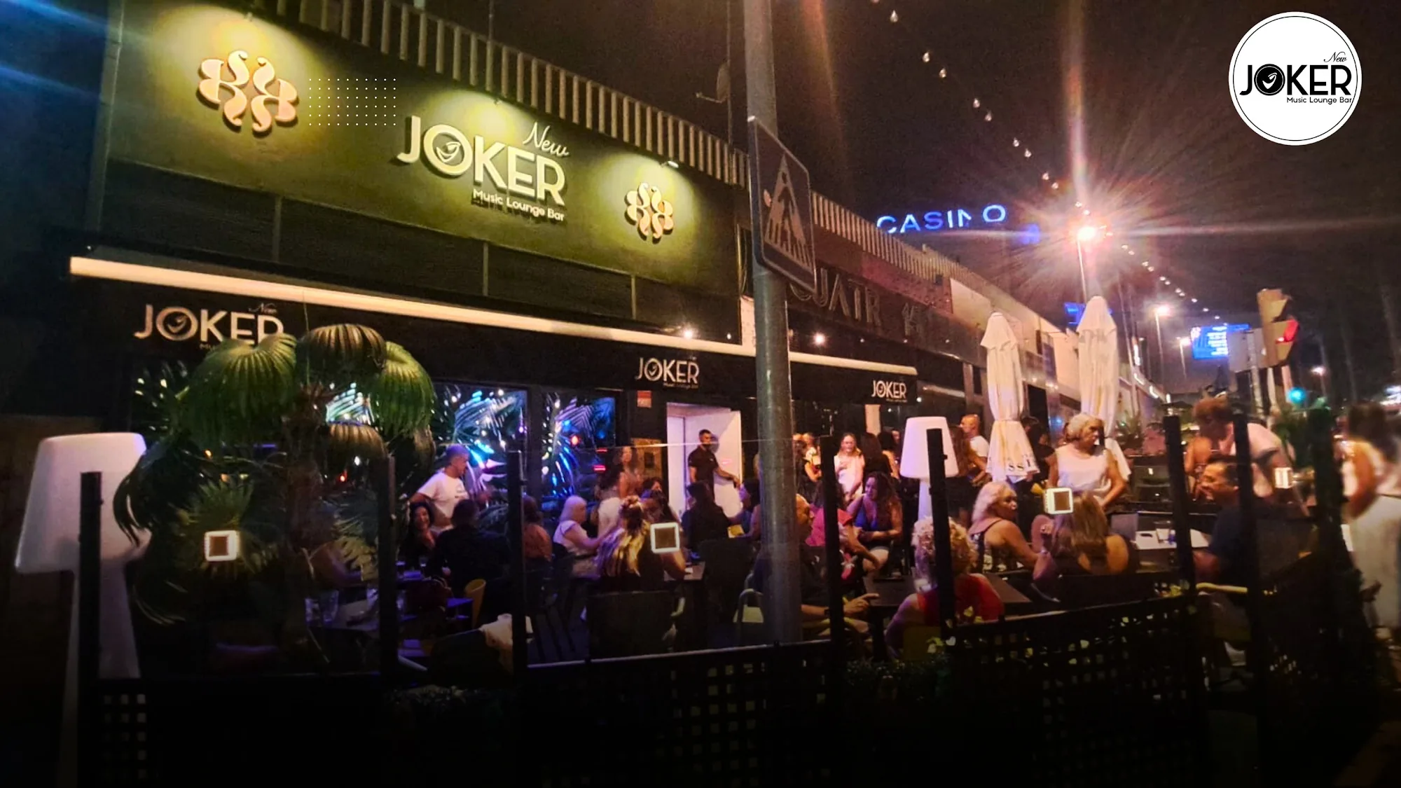 New Joker Music Lounge Bar Tomares — lively night exterior with crowd and Joker Music Lounge Bar signage