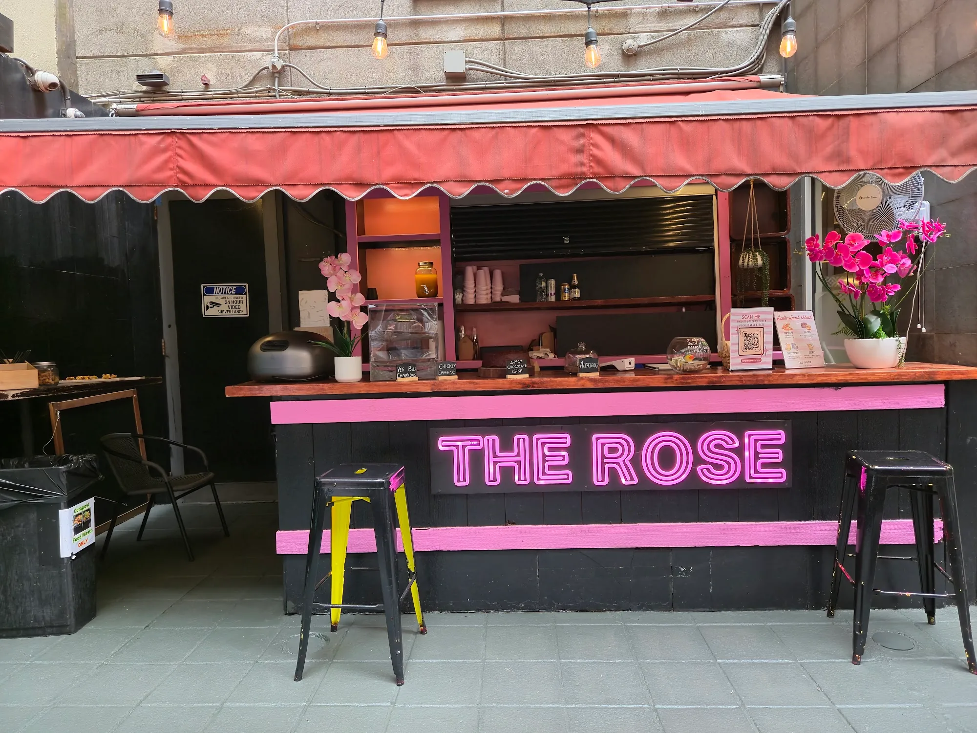 The Rose NYC venue exterior with pink neon signage and bar counter — salsa, bachata, kizomba, zouk venue in New York