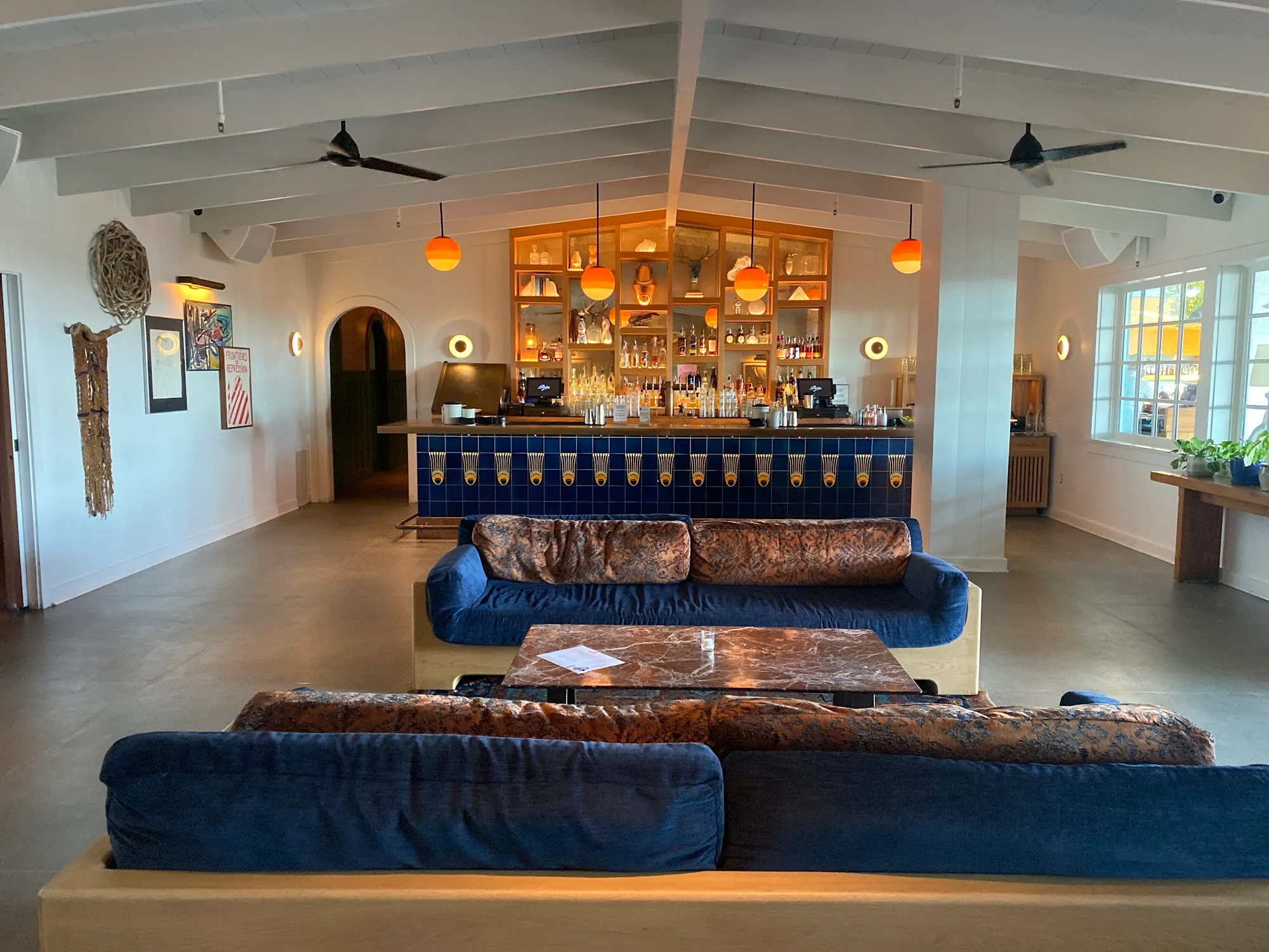 Spacious lounge with blue-tiled bar and velvet sofas at The Bungalow in Long Beach — salsa, bachata venue in Long Beach
