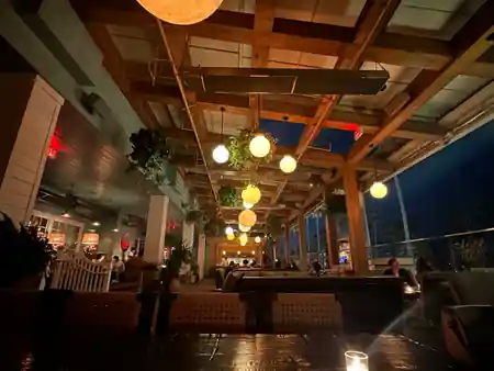 Open-air patio with globe pendant lights at night at The Bungalow in Long Beach — salsa, bachata venue in Long Beach