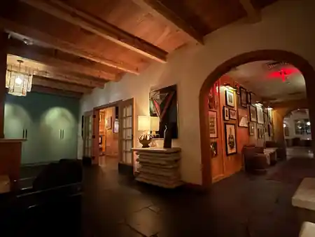 Wood-beamed corridor with framed art at The Bungalow in Long Beach — salsa, bachata venue in Long Beach
