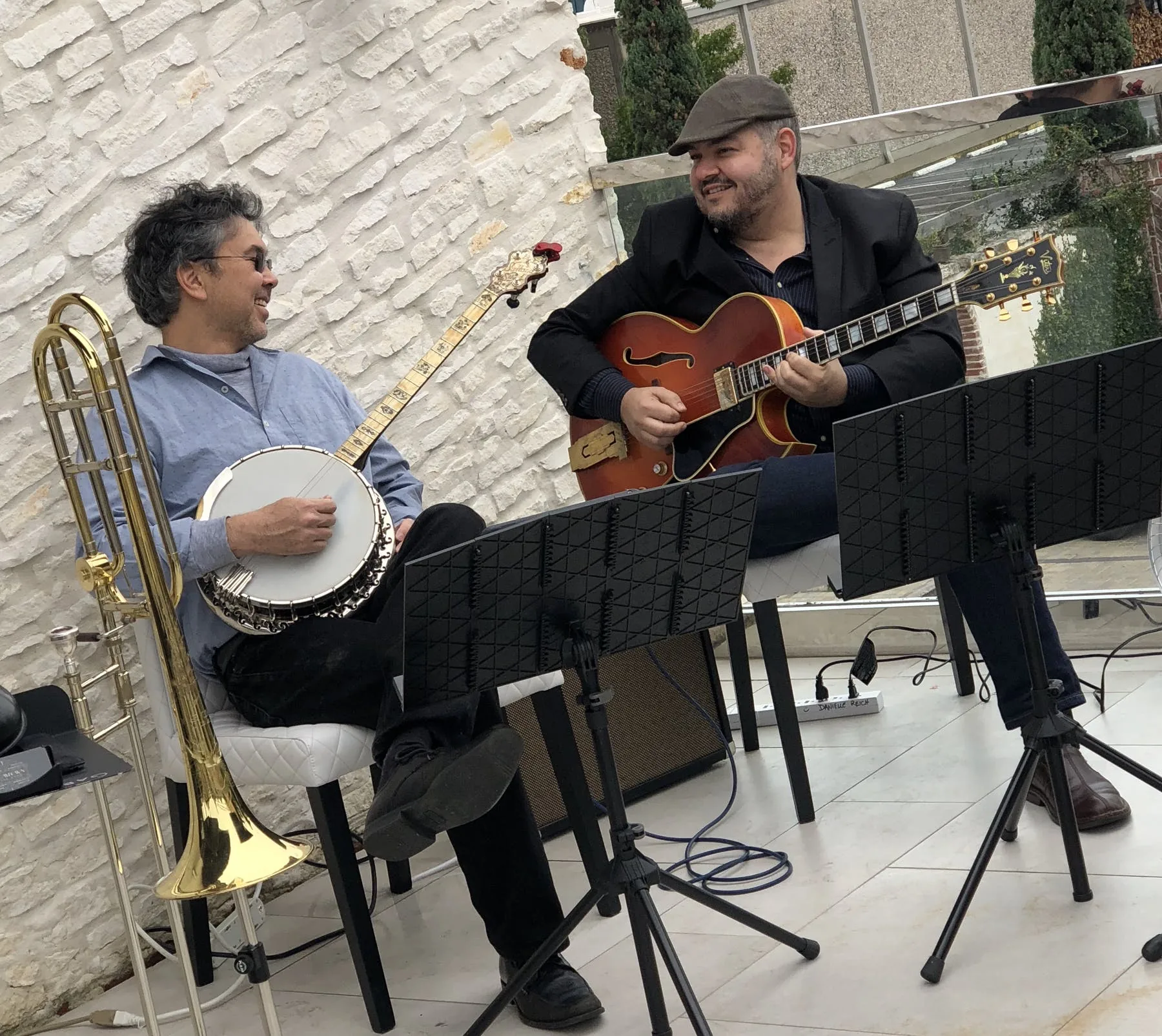 Live band with banjo and guitar performing on the patio at Ivy Bar & Bistro, Houston