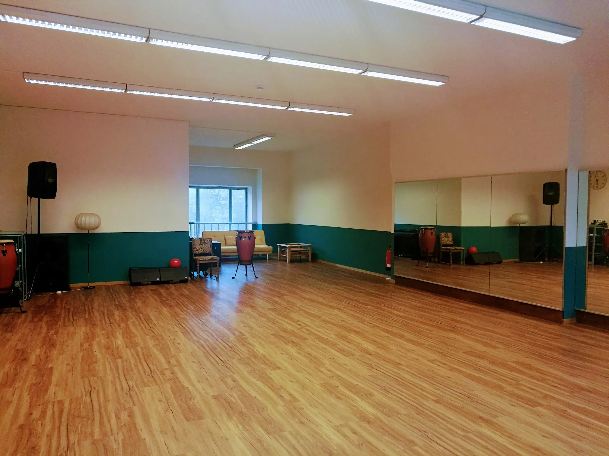 Dance studio with mirrored walls, conga drums and wooden floor at Baileo Tanzstudio, Leipzig