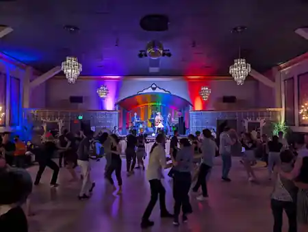 Packed social dance floor with live band and disco ball at Verdi Club San Francisco — salsa venue in San Francisco