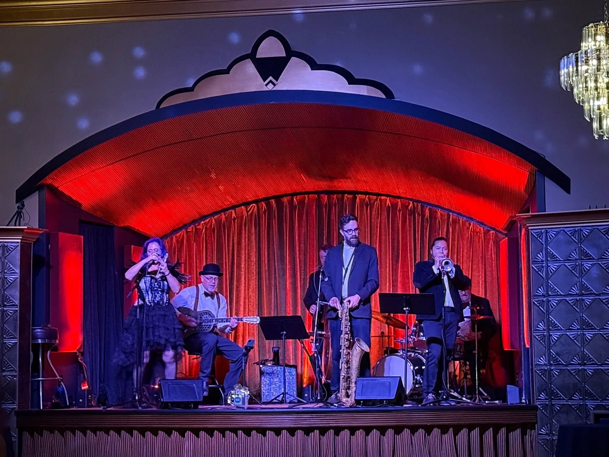Live jazz band performing on the red-curtained stage at Verdi Club San Francisco