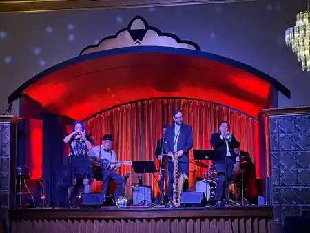Live jazz band performing on the red-curtained stage at Verdi Club San Francisco — salsa venue in San Francisco
