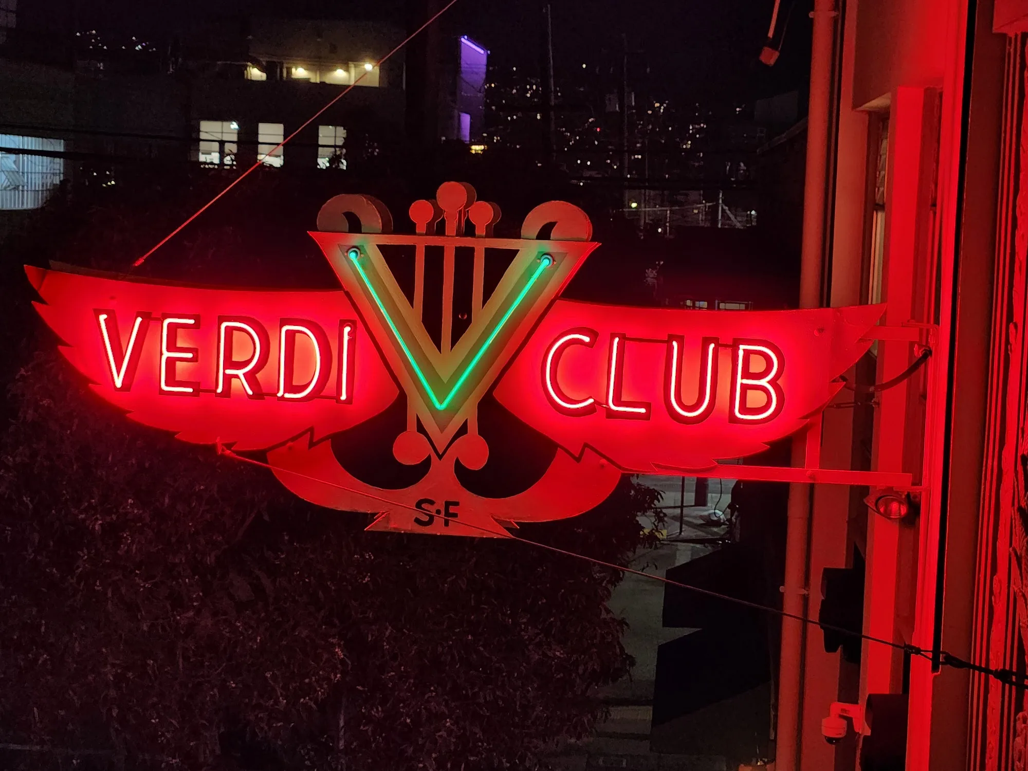 Iconic illuminated Verdi Club neon sign at night in San Francisco