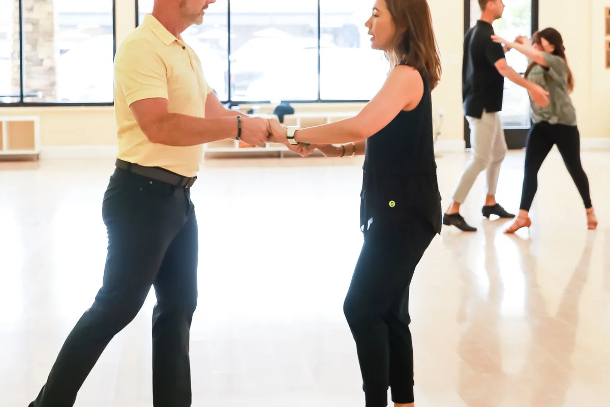 Couples practicing partner dancing during a group class at Sway Ballroom in Laguna Hills