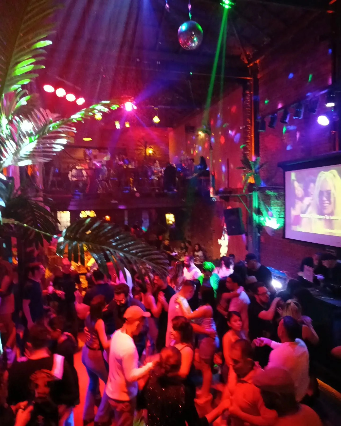 Packed dance floor with couples dancing under colorful lights and a disco ball at Velho Pietro, Sao Paulo — salsa, bachata, other venue in Sao Paulo