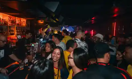 OUT Latin Club Amsterdam — busy event night with crowd at the bar and DJ visible in the background — bachata, salsa venue in Amsterdam