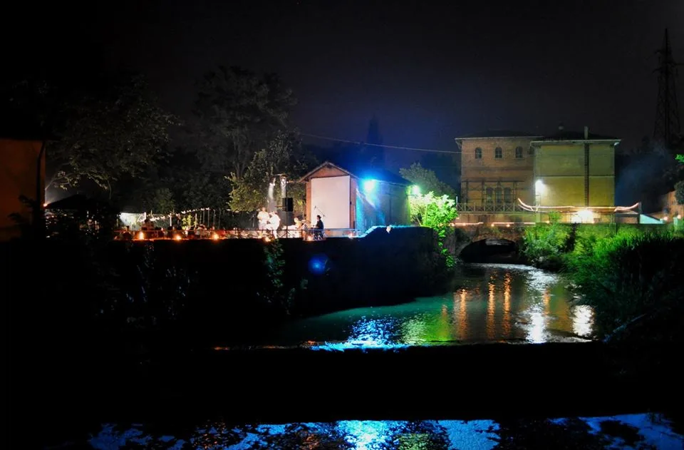Battiferro outdoor stage at night by the canal in Bologna