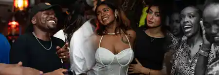 Smiling crowd socializing during a party night at Cafe Sor in Oslo, salsa, bachata venue in Oslo