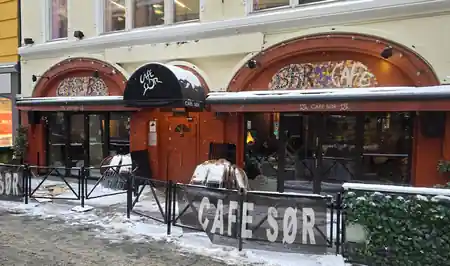 Snow-covered street exterior of Cafe Sor with CAFE SOR signage in Oslo, salsa, bachata venue in Oslo