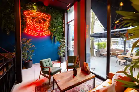 BrewDog Rotterdam lounge interior with neon sign and bar seating — kizomba venue in Rotterdam