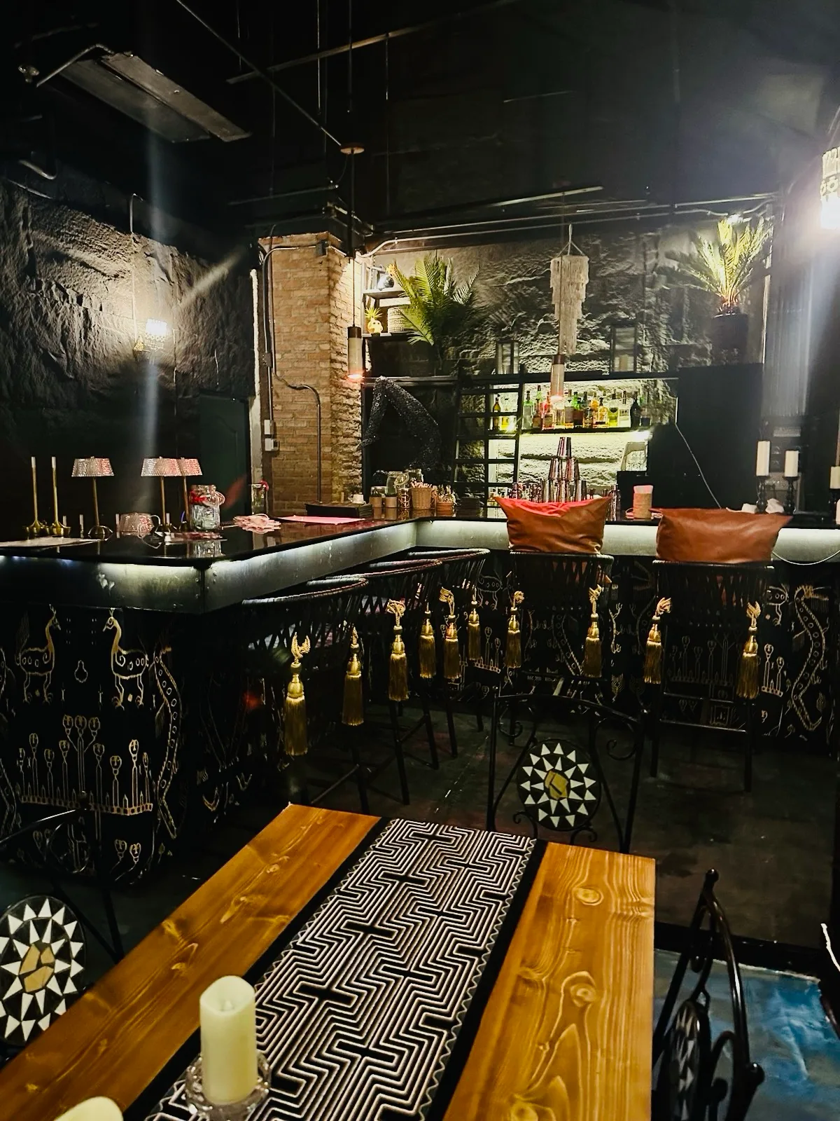 PuraVida Entertainment Chiang Mai — intimate bar interior with ornate iron bar counter and tropical plants