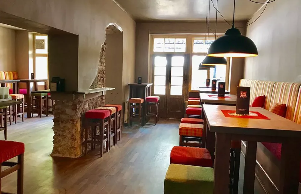 MI Barrio Vienna rustic bar interior with exposed stone walls and colorful seating