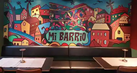 MI Barrio Vienna interior with colorful Latin American mural and seating area — bachata venue in Vienna