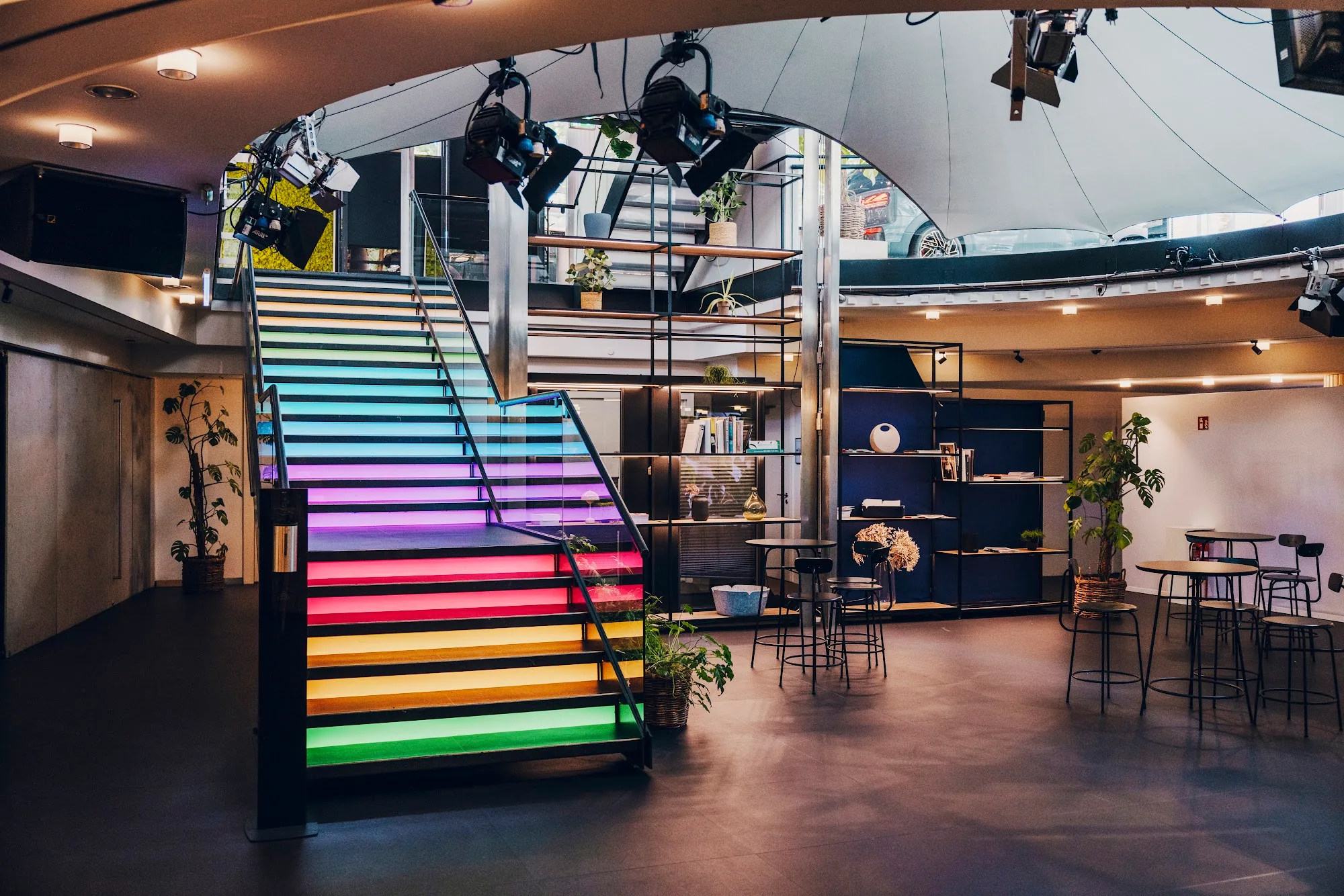 Event space with colorful lit staircase and high tables at MINI Pavillon, Munich — salsa venue in Munich