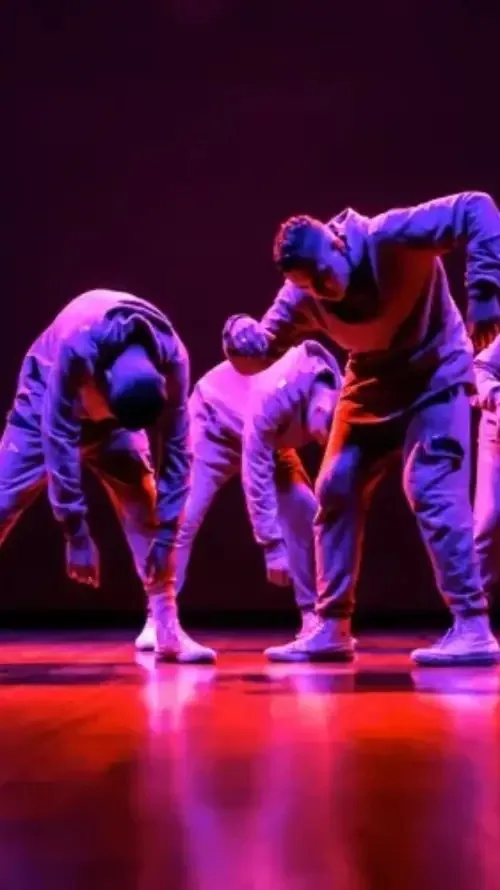 Dancers performing on stage under dramatic lighting at Uppsala Danscenter