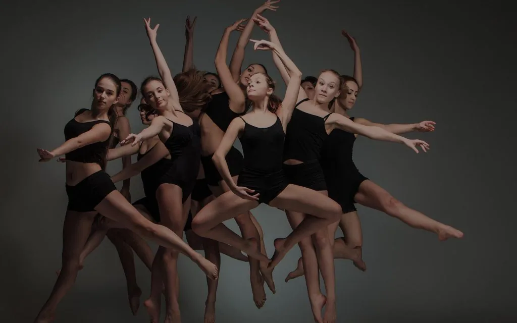 Dance troupe in dynamic group pose at Uppsala Danscenter studio