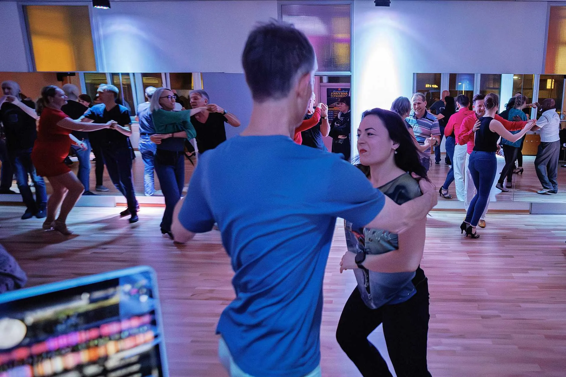 Couples dancing salsa on the wooden floor at Mice Dance School in Munich
