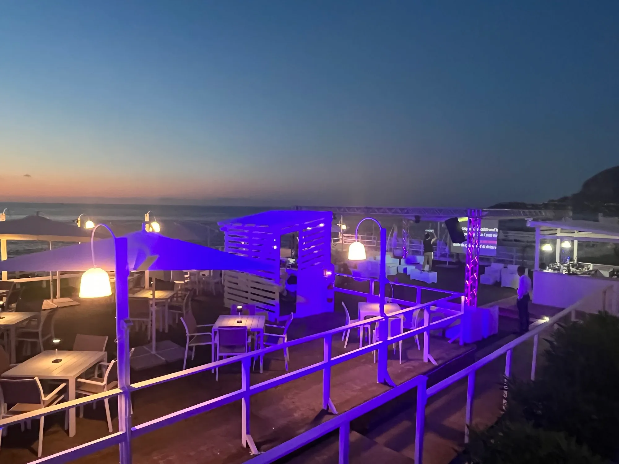 Sunset stage setup with DJ booth on the terrace at Sea Public, Aspra